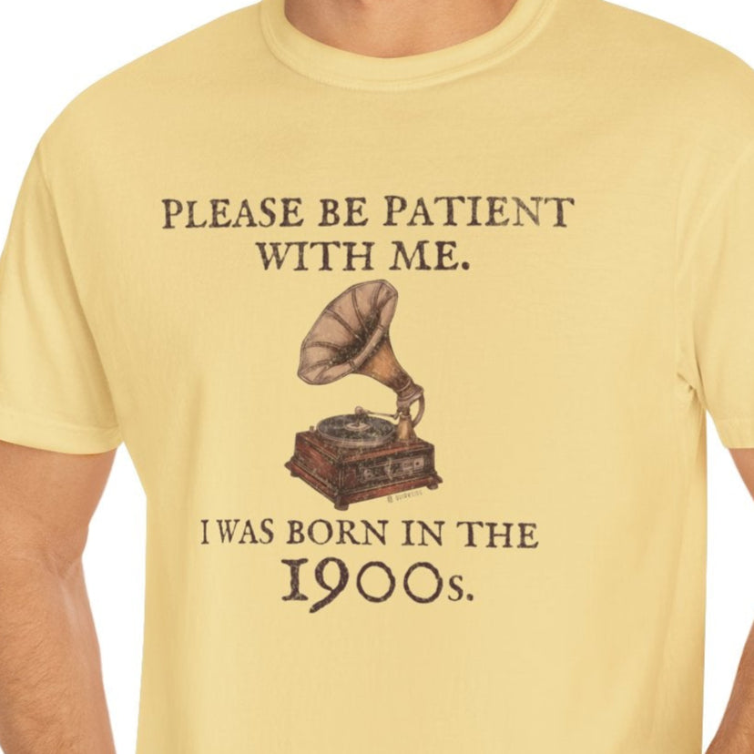 Man wearing a yellow t-shirt with a graphic and text, standing against a white background