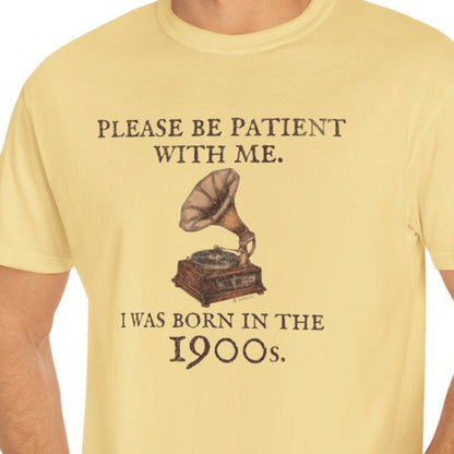 Man wearing a yellow t-shirt with a graphic and text, standing against a white background