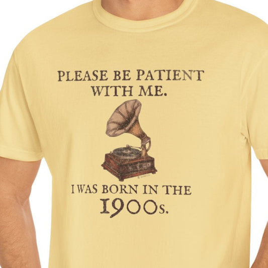 Man wearing a yellow t-shirt with a graphic and text, standing against a white background