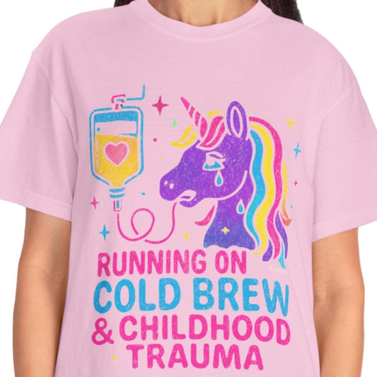 Person wearing a pink t-shirt with a unicorn graphic and text on a white background