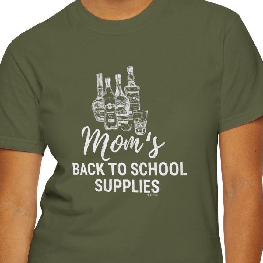 Person wearing a green t-shirt with 'Mom's Back to School Supplies' text and bottle graphic.